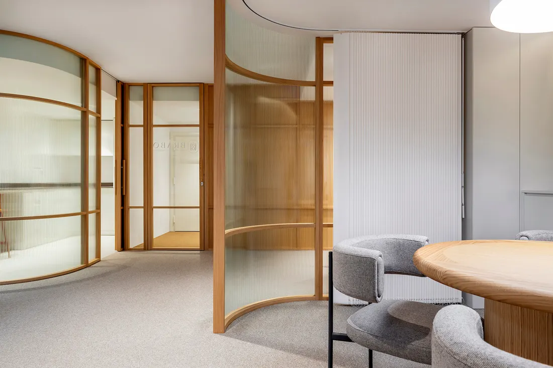 Modern commercial office with curved glass meeting areas