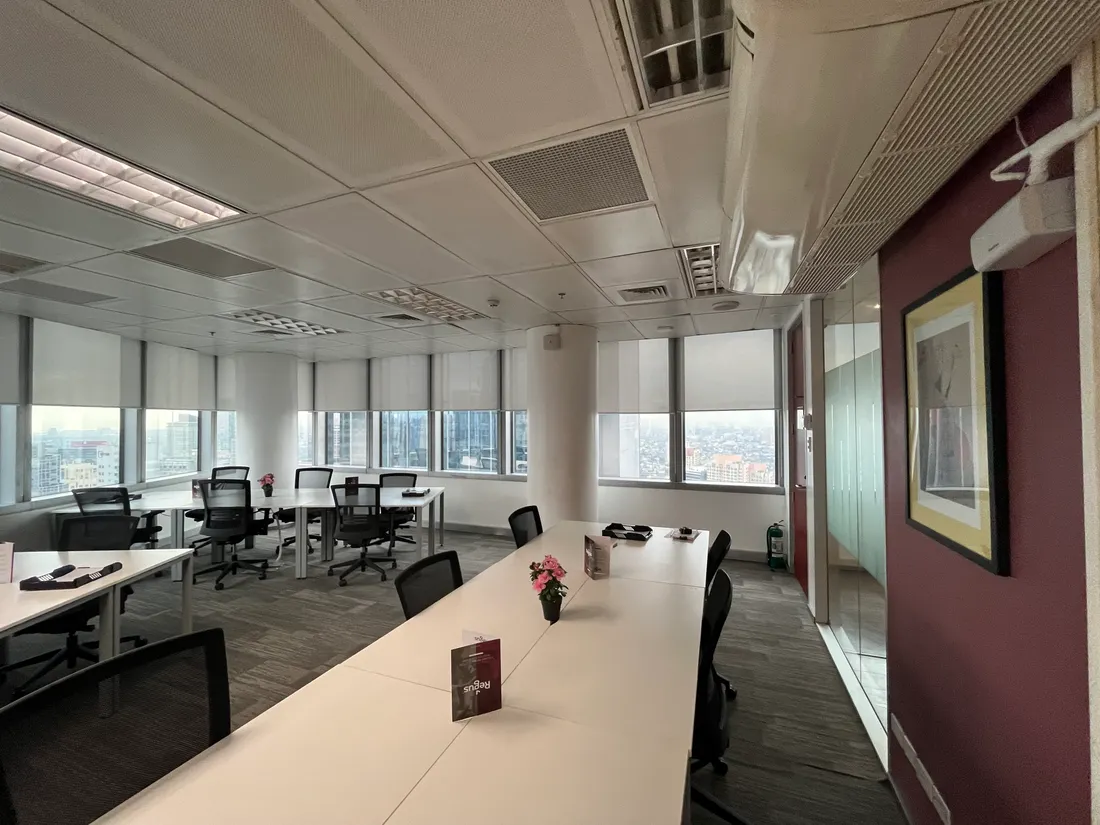 Commercial office meeting area with tables and city views